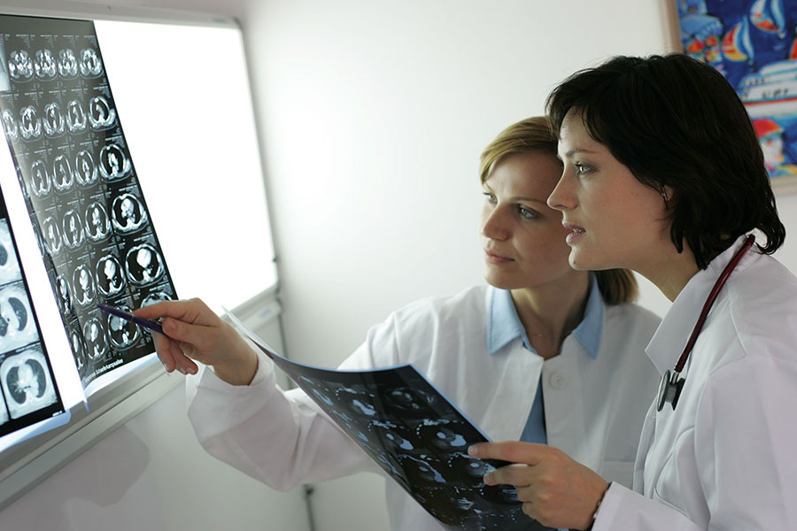 Zwei Ärztinnen betrachten die Bilder einer Computertomografie.