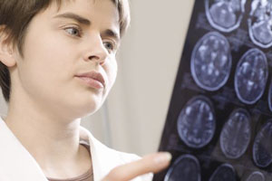Eine Ärztin betrachtet CT-Aufnahmen des Gehirns.